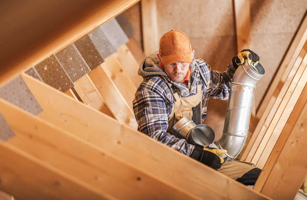 technician installing attic ventilation elements