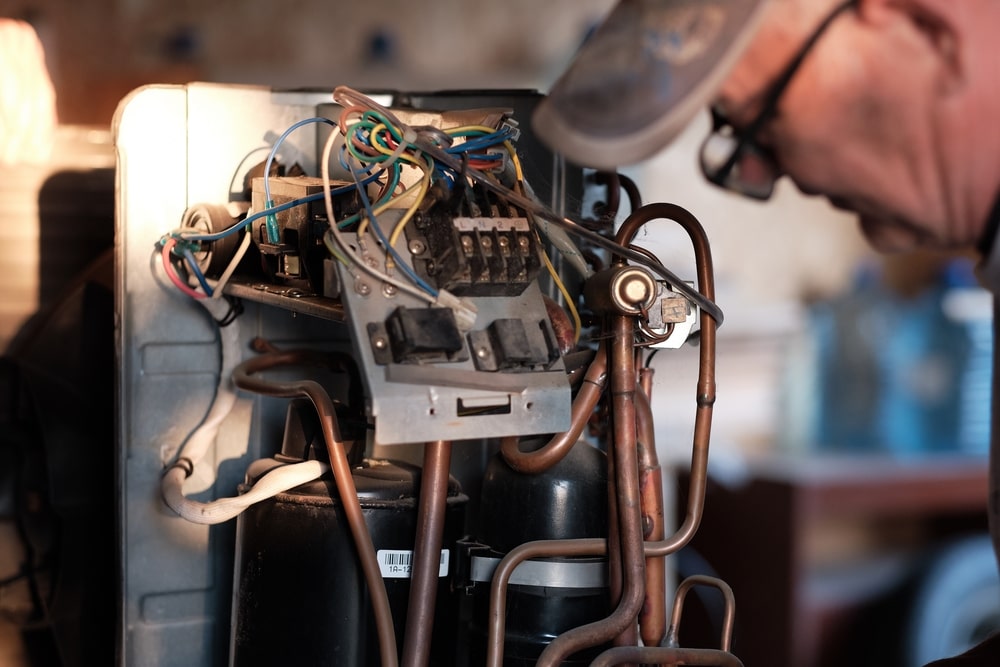 technician repairing furnace parts