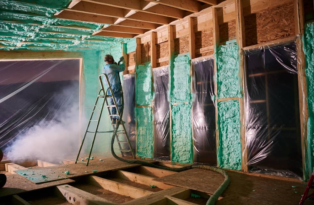 worker spraying polyurethane foam fir insulating